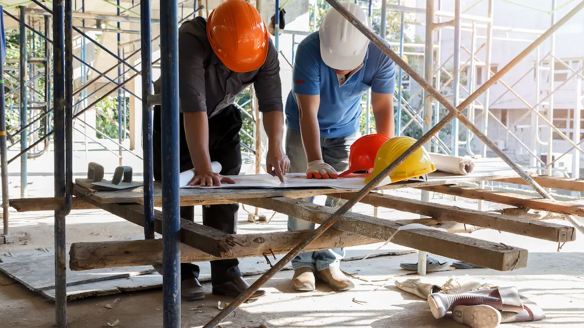 Contractor reviewing project lien documents alongside mortgage paperwork to evaluate priority on an Illinois construction site